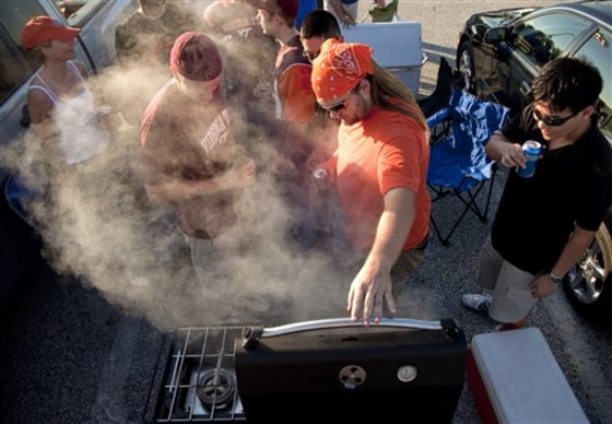 Virginia Tech fans tailgate in the FedEx Field parking lot Sept. 6 before an NCAA college football game against Boise State in Landover, Md. Flying back to see a game at your alma mater? Flight choices to smaller college towns may be more difficult, but fall fare sales are abundant.